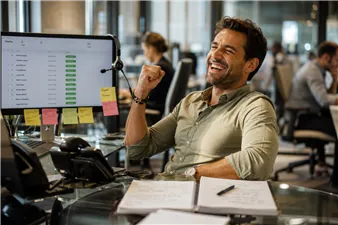 Sales rep smiling at an up-to-date client tracking dashboard